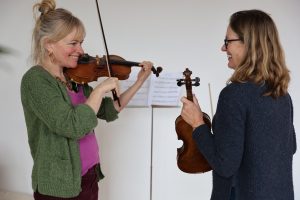 Fiona Barrow teaching violin to a beginner